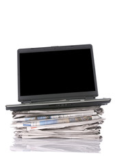 Laptop On Stacking Newspaper