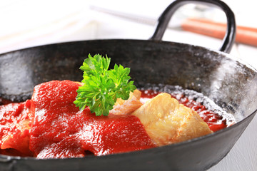 Pan fried fish fillets with tomato sauce