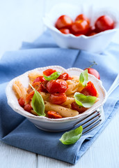 Penne pasta with cherry tomatoes and basil