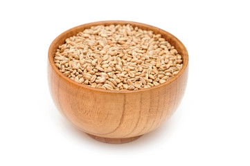 grain wheat in wooden bowl isolated on white