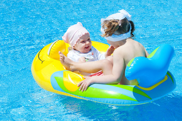 Children play in a pontoon swim in the pool