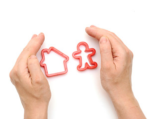 Hands and a model home