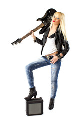 Sexy woman in blue jeans posing with black electric guitar