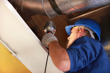 worker examining an attic