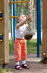 Little girl playing with a thick sport rope