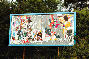 Billboard with old torn posters