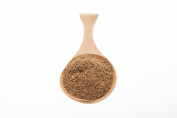 Coriander powder on a wooden spoon