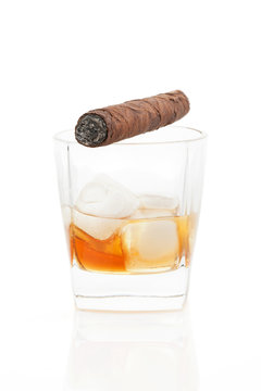 Cigar and whiskey with ice isolated.