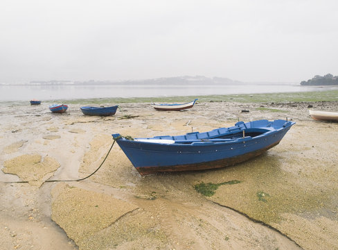 Boats in the sand on a cloudy day