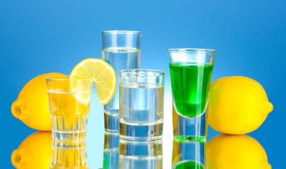 a variety of alcoholic drinks on blue background