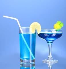 a variety of alcoholic drinks on blue background