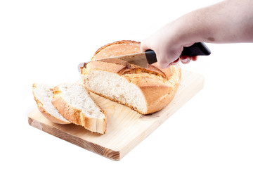 A woman is making bread slices of an isolated Hogaza (Spanish br