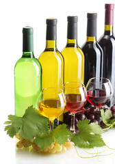 bottles and glasses of wine and ripe grapes isolated on white