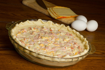 Quiche being prepared with ingredients in background
