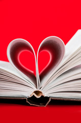pages of a book curved into a heart shape