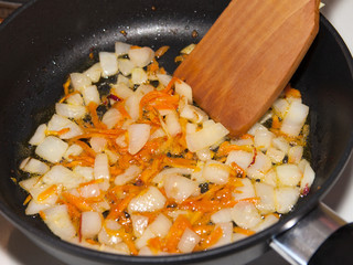 Frying carrots and onions.