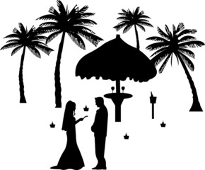 Wedding couple, groom and bride between the palms on the beach