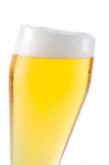 Beer into glass isolated on white