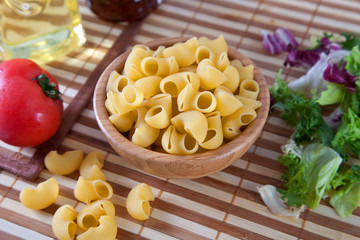 uncooking pasta in bamboo bowl