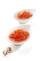 Red caviar in white bowl.