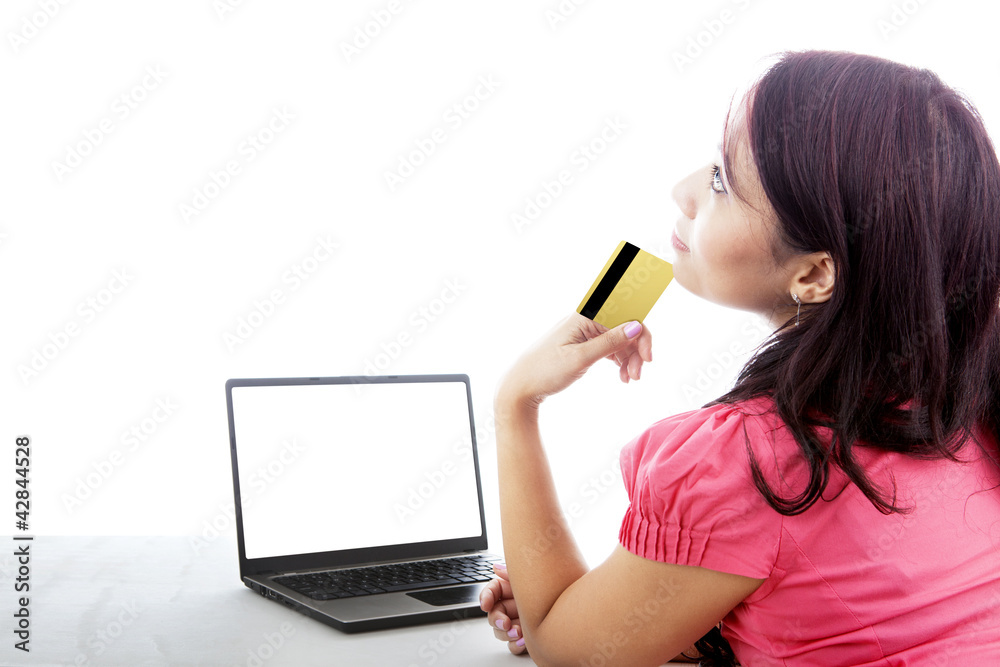 Wall mural Thoughtful woman shopping online