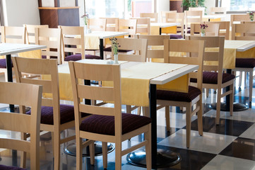 The interior of a cafe with wooden tables
