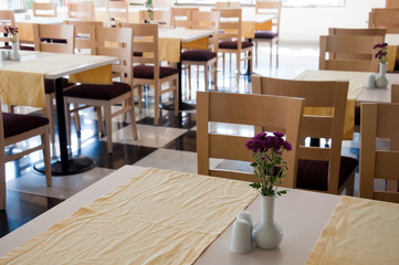 The interior of a cafe with wooden tables