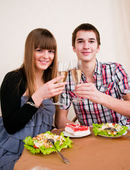 Young, attractive, happy, smiling couple celebrating with champa