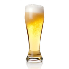 Beer into glass isolated on white