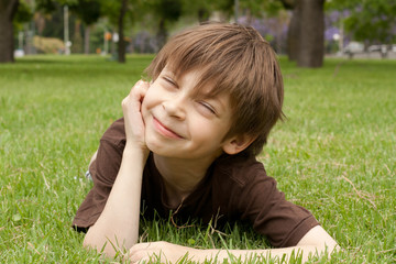 happy kid lying on grass