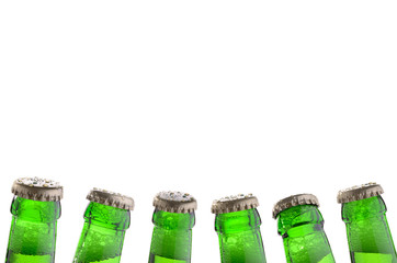 six green bottle necks with bottle caps