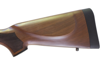 Wood rifle buttstock with checkering at the wrist and wearing a rubber recoil pad