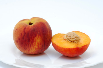 Fototapeta na wymiar Whole and half peach