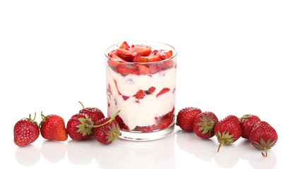Glass of ripe strawberries with cream isolated on white