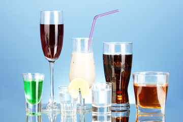 a variety of alcoholic drinks on blue background