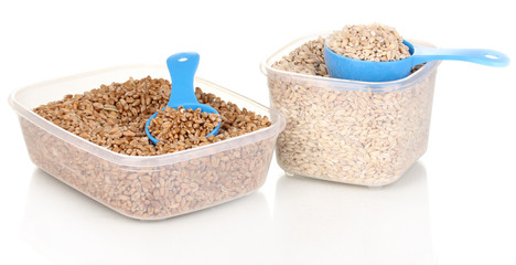 Measuring spoons and plastic containers with grain isolated