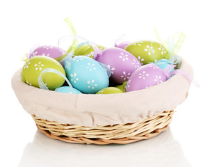 Colorful easter eggs in basket isolated on white