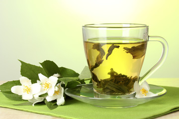 cup of green tea with jasmine flowers