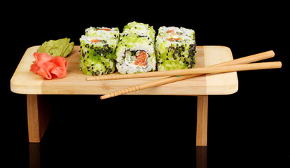 Tasty rolls served on wooden plate isolated on black