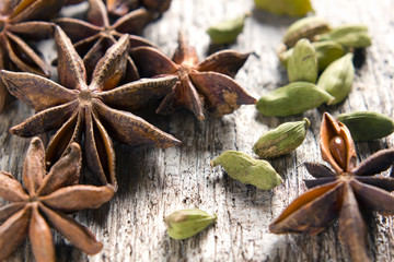 Spices anise stars and cardamom on the vintage wooden surface