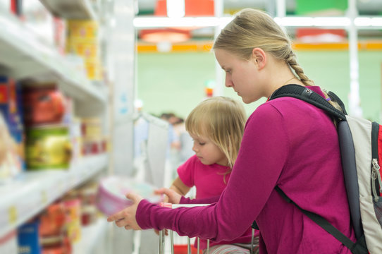 Mother and daughter shopping in sweets section in supermarket