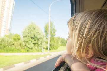 Adorable baby look at  window riding on city bus