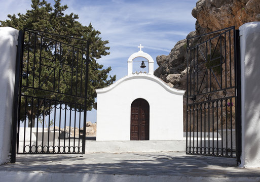 open gate to white church
