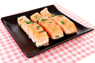 Plate with fresh salmon on checkered napkin
