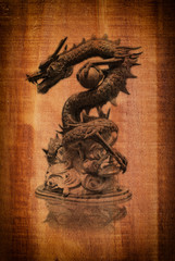 Chinese style dragon statue on the wood texture.