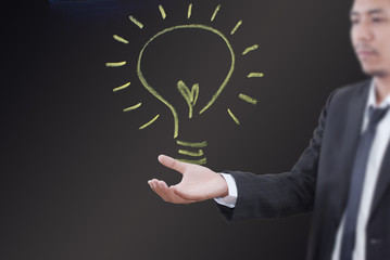 Businessman holding light bulb concept.