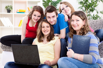 group of teens  with laptop