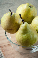 Close-up of ripe pears in a glass bowl