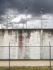prison walls with barbed wired fence