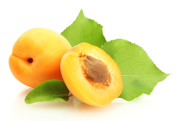 ripe sweet apricots with green leaves isolated on white